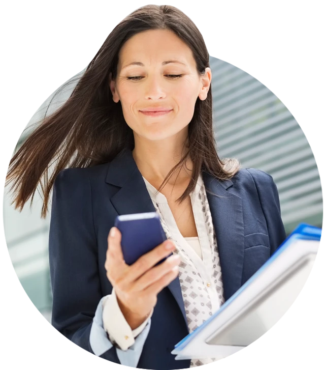 Businesswoman Using Cell Phone In Office